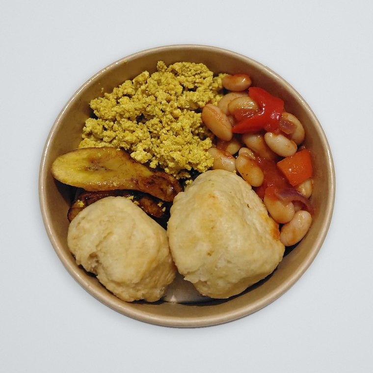 Vegan breakfast of dumplings, smoky beans, scrambled tofu and fried plantain, freshly made by Rooted Soul